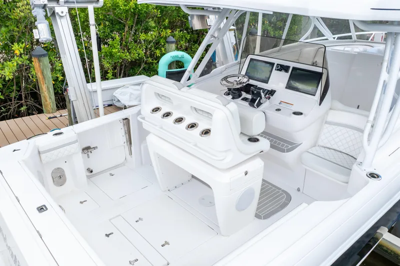  Yacht Photos Pics 2023 Intrepid 345 Valor boat interior with helm, seating, and fishing rod holders.
