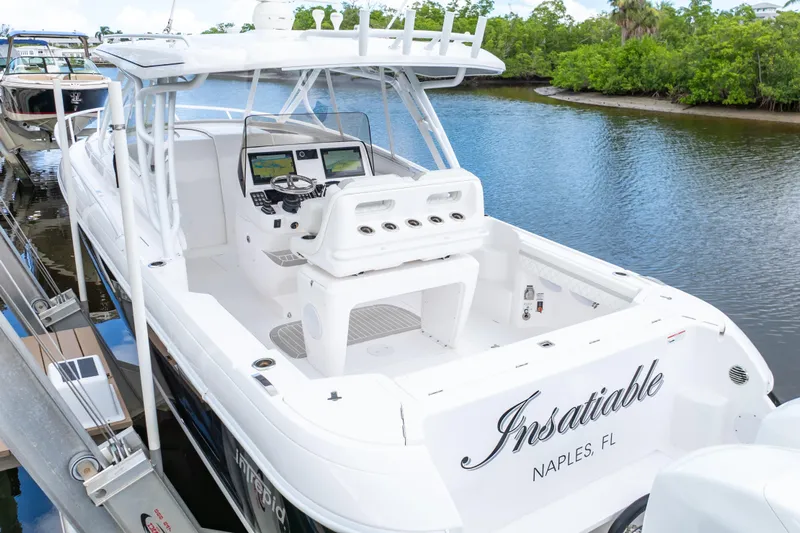  Yacht Photos Pics 2023 Intrepid 345 Valor boat docked in Naples, FL, featuring sleek design and modern controls.