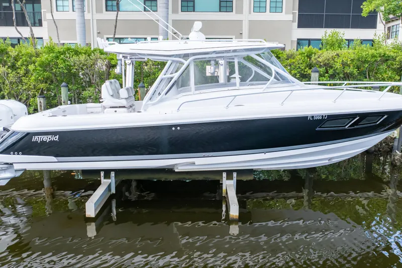 Yacht Photos Pics 2023 Intrepid 345 Valor boat docked, sleek design, black and white exterior.