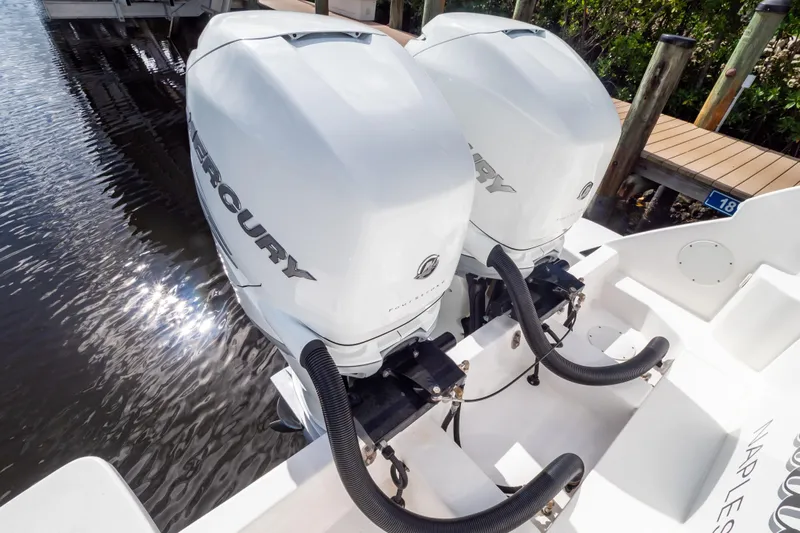  Yacht Photos Pics Twin Mercury outboard engines on a 2023 Intrepid 345 Valor boat, docked by water.