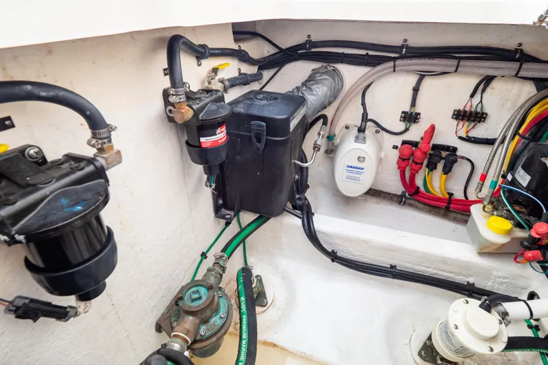  Yacht Photos Pics Engine compartment of 2023 Intrepid 345 Valor, showcasing wiring and mechanical components.