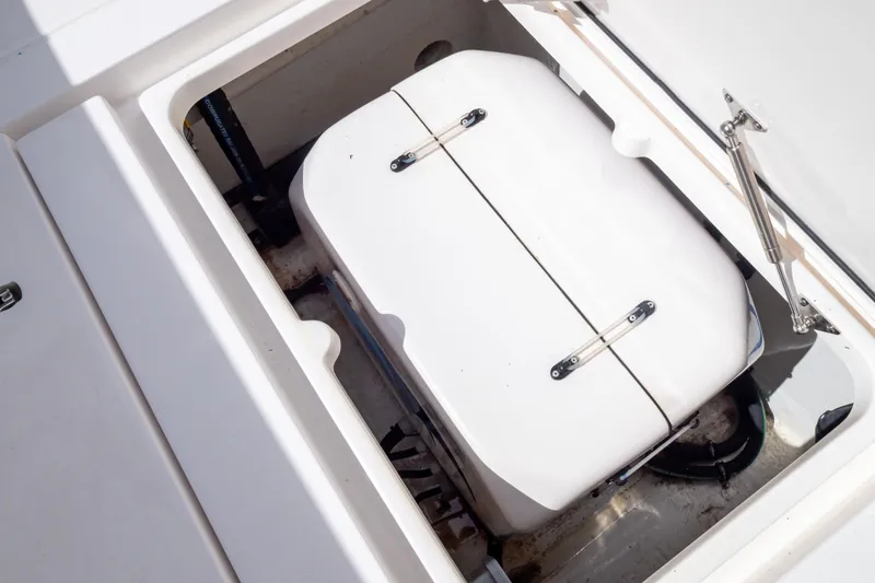  Yacht Photos Pics Storage compartment on 2023 Intrepid 345 Valor boat, featuring a white hatch and hydraulic support.