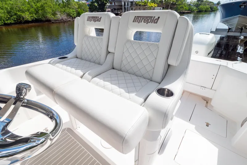  Yacht Photos Pics Luxurious seating on 2023 Intrepid 345 Valor boat, featuring elegant white upholstery and cup holders.