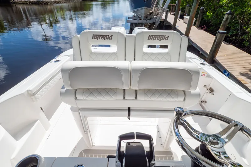  Yacht Photos Pics 2023 Intrepid 345 Valor boat interior with white seating and steering wheel.