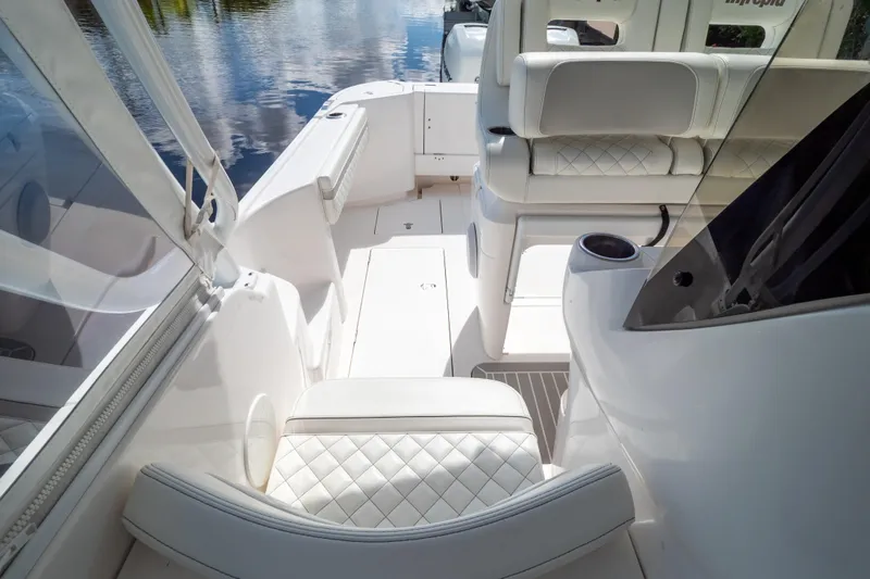  Yacht Photos Pics 2023 Intrepid 345 Valor boat interior with white seating and sleek design.