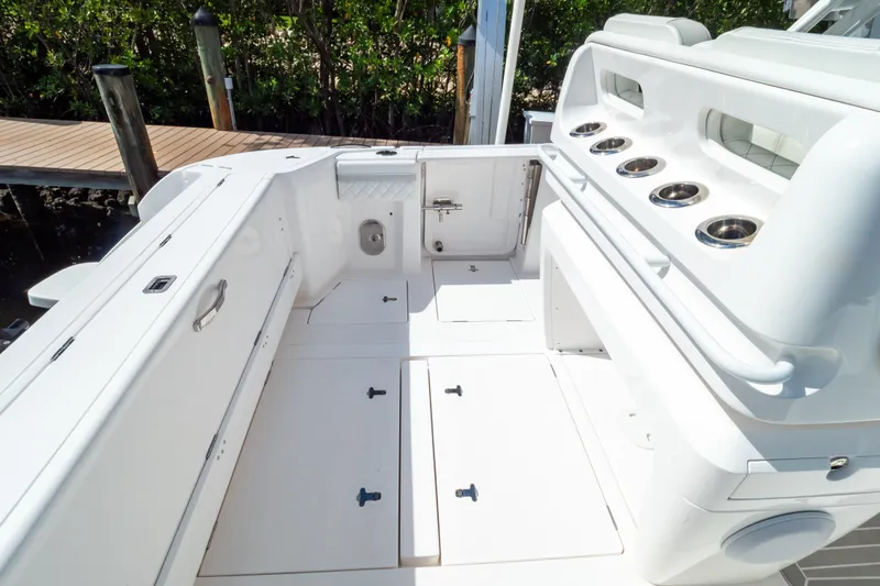  Yacht Photos Pics 2023 Intrepid 345 Valor boat deck with storage compartments and cup holders.