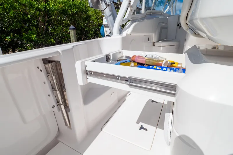  Yacht Photos Pics 2023 Intrepid 345 Valor boat with open storage drawer, showcasing onboard amenities.