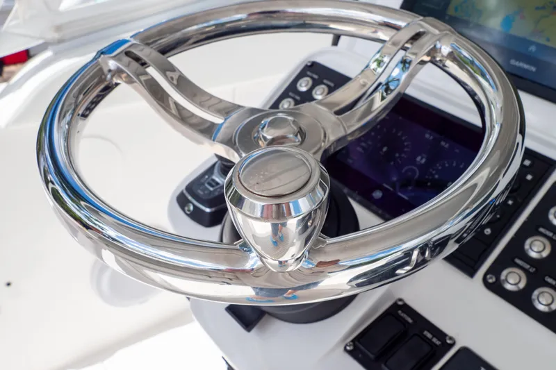  Yacht Photos Pics Steering wheel of 2023 Intrepid 345 Valor boat with modern dashboard controls.