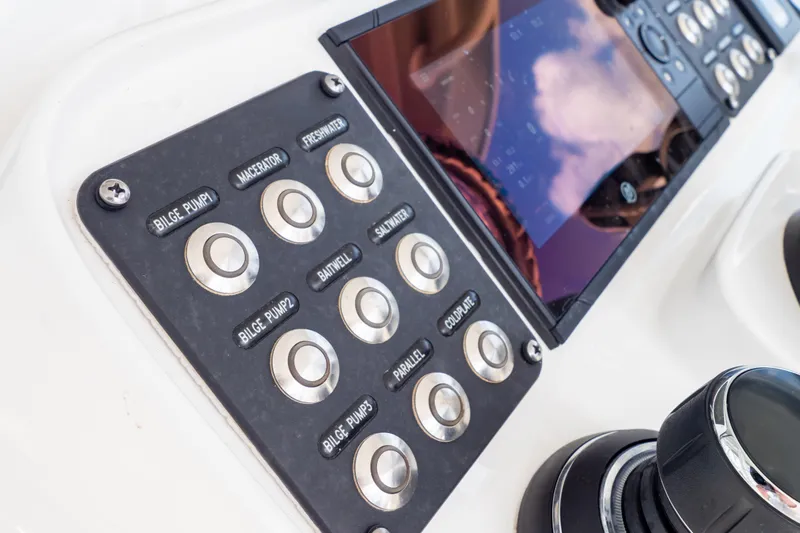  Yacht Photos Pics Control panel of 2023 Intrepid 345 Valor boat with labeled buttons and display screen.