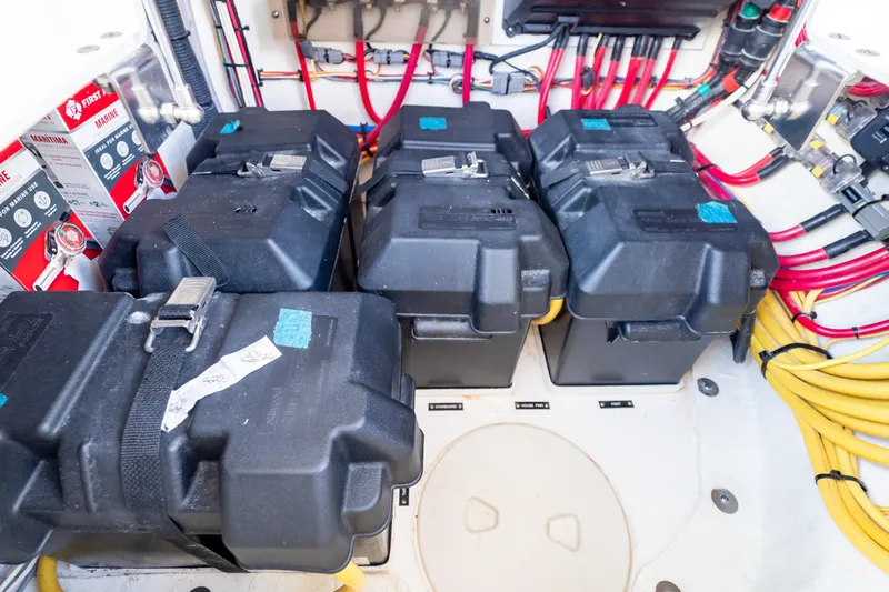  Yacht Photos Pics 2023 Intrepid 345 Valor boat battery compartment with multiple black battery boxes and wiring.