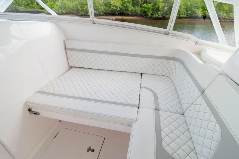  Yacht Photos Pics Luxurious seating on 2023 Intrepid 345 Valor boat, featuring quilted white upholstery.