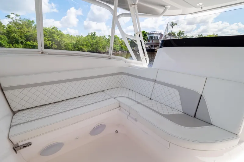  Yacht Photos Pics 2023 Intrepid 345 Valor boat interior with elegant white seating and scenic view.
