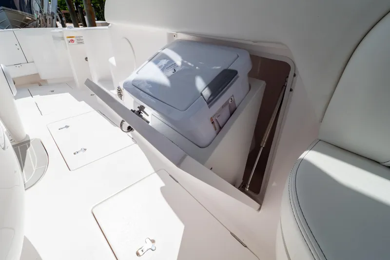  Yacht Photos Pics 2023 Intrepid 345 Valor boat interior with storage compartment and seating.