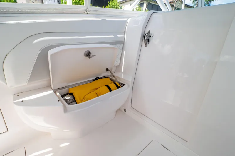  Yacht Photos Pics 2023 Intrepid 345 Valor boat storage compartment with yellow life jacket inside.