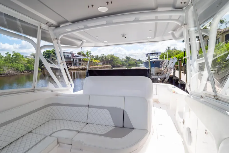  Yacht Photos Pics 2023 Intrepid 345 Valor boat interior with white seating and waterfront view.