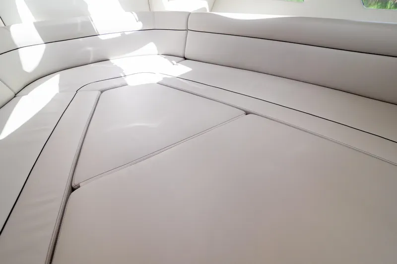  Yacht Photos Pics Luxurious seating area on 2023 Intrepid 345 Valor boat, featuring sleek white upholstery.