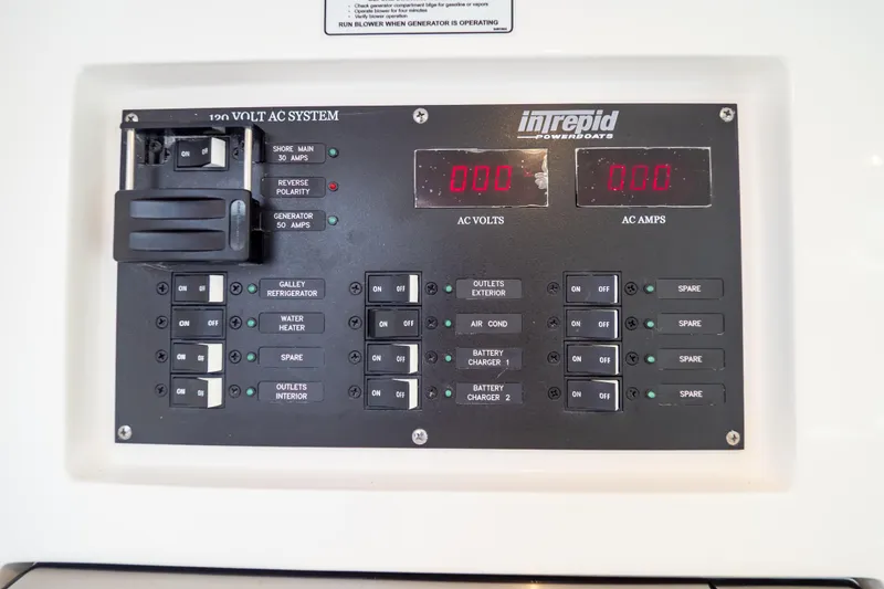  Yacht Photos Pics Control panel of 2023 Intrepid 345 Valor boat, showing AC system switches and indicators.