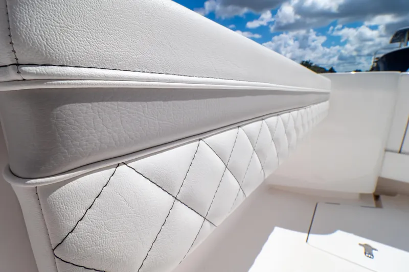  Yacht Photos Pics Luxurious white leather seating on 2023 Intrepid 345 Valor boat under blue sky.