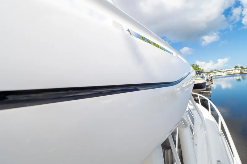  Yacht Photos Pics Side view of 2023 Intrepid 345 Valor boat docked by calm waters.