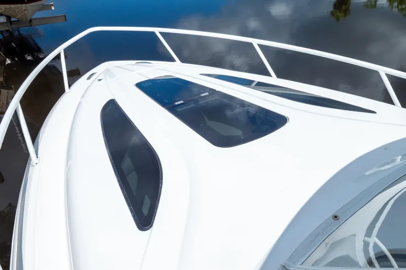  Yacht Photos Pics 2023 Intrepid 345 Valor boat deck with sleek windows and railing, reflecting on water.