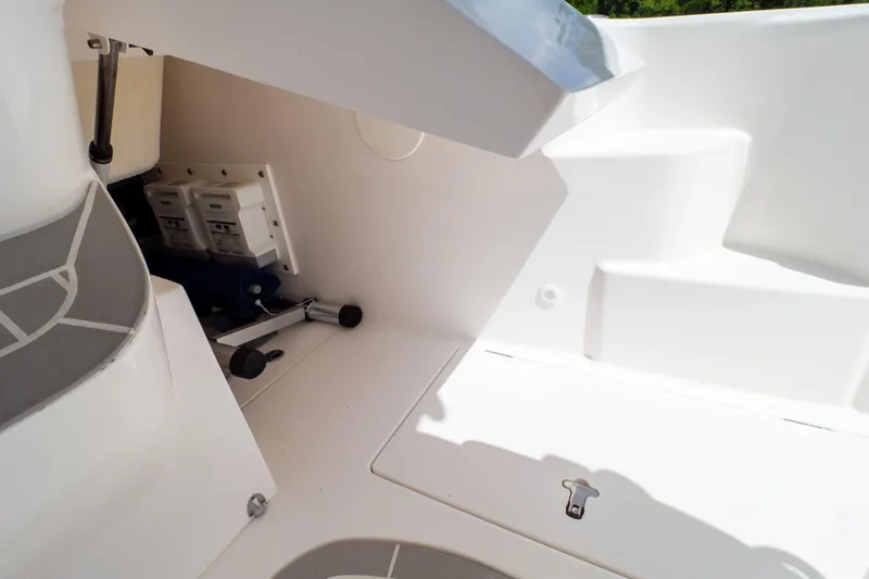  Yacht Photos Pics 2023 Intrepid 345 Valor boat interior, showcasing storage compartment and hydraulic components.