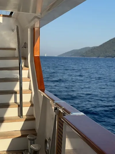 Koru Yacht Photos Pics View from 1983 Feadship Custom yacht, overlooking serene ocean and distant hills.