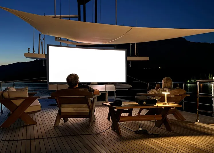 Koru Yacht Photos Pics Luxury yacht deck with outdoor movie setup at night, Feadship Custom 1983.