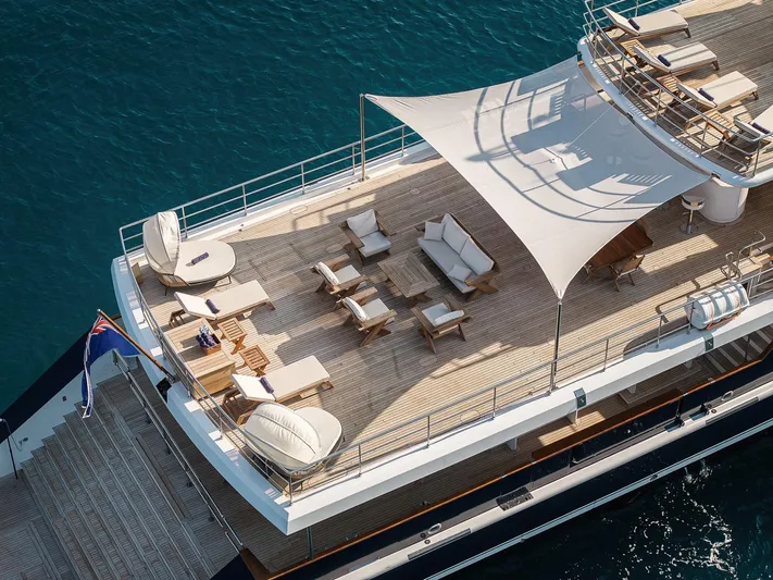 Koru Yacht Photos Pics Luxurious 1983 Feadship Custom yacht deck with elegant seating and sunshade.