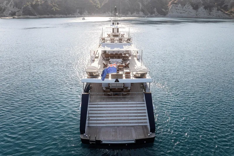 Koru Yacht Photos Pics Luxury 1983 Feadship Custom yacht on serene water, rear view.