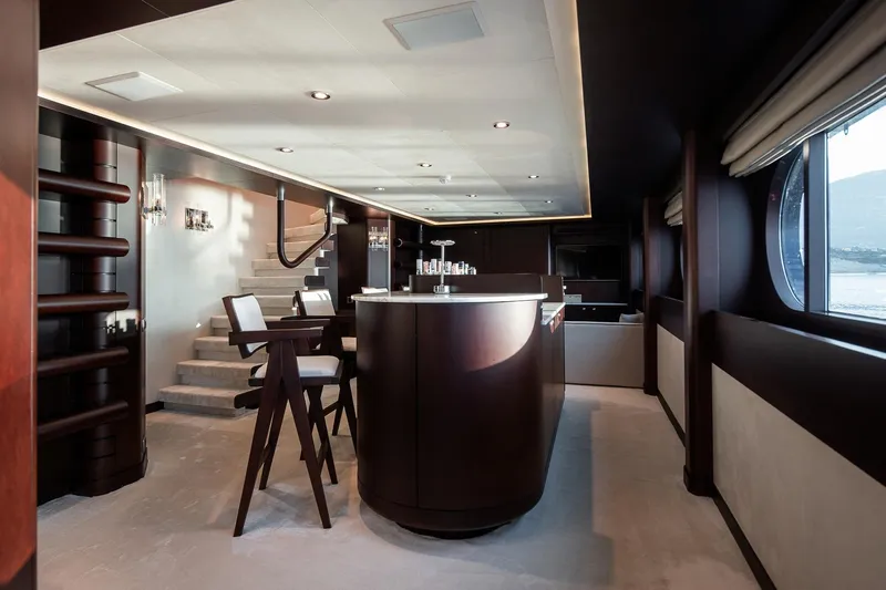 Koru Yacht Photos Pics Luxurious interior of 1983 Feadship Custom yacht with elegant bar and seating area.