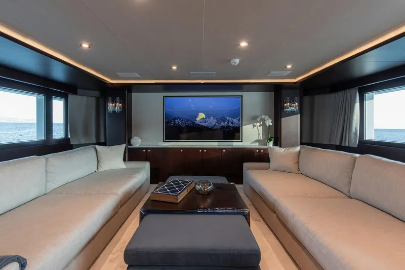 Koru Yacht Photos Pics Luxurious yacht interior with modern decor, featuring large sofas and a flat-screen TV.