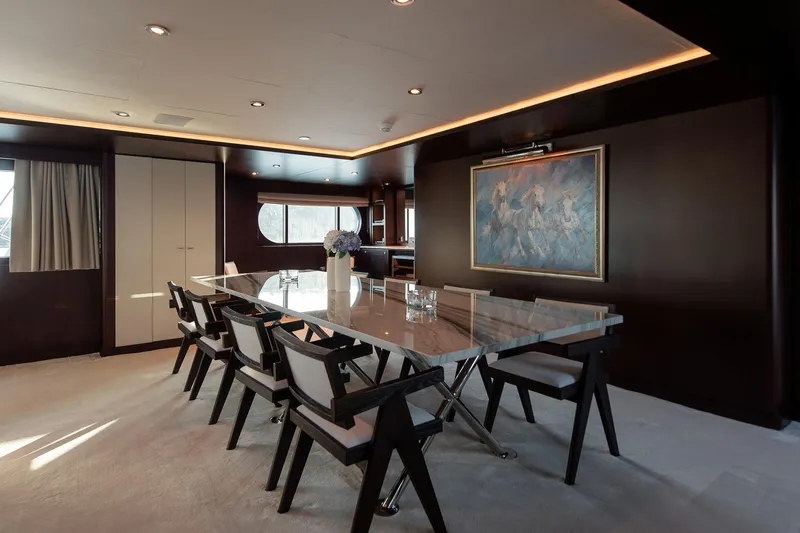 Koru Yacht Photos Pics Luxurious dining area on 1983 Feadship Custom yacht with modern decor and elegant furnishings.