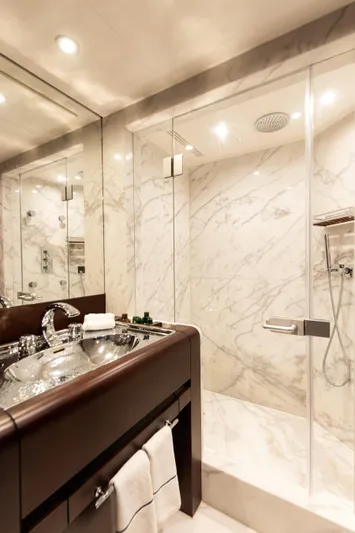 Koru Yacht Photos Pics Luxurious marble bathroom in 1983 Feadship Custom yacht with modern fixtures.