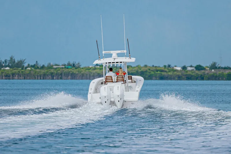 In Stock Yacht Photos Pics 2026 Jupiter 32 boat cruising on open water with passengers onboard.