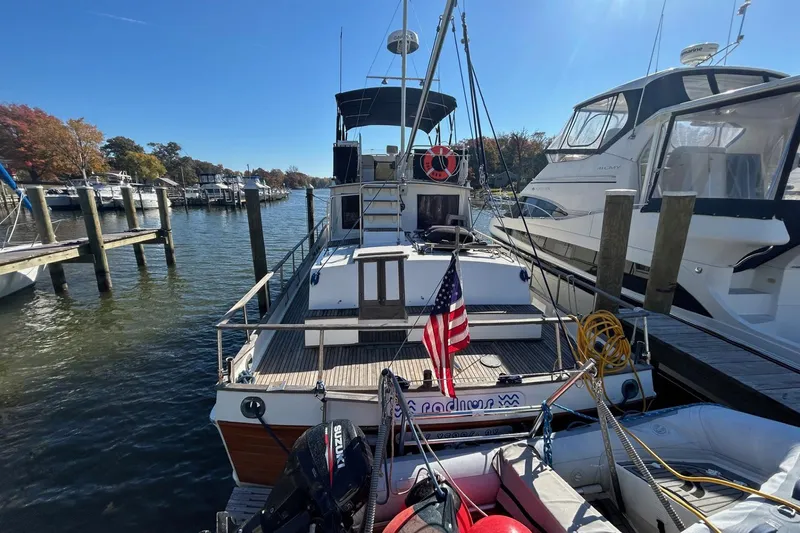 Radius Yacht Photos Pics 1986 Grand Banks 42 Classic yacht docked at marina with American flag.