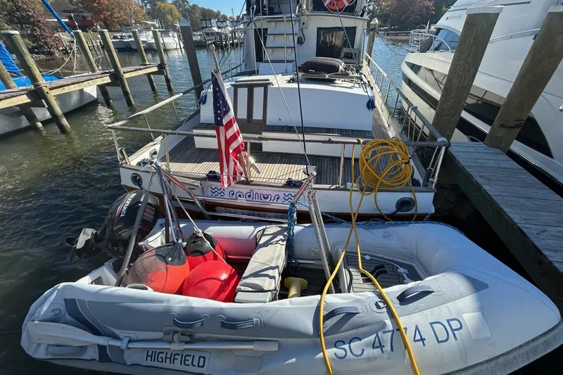 Radius Yacht Photos Pics 1986 Grand Banks 42 Classic yacht docked with inflatable boat and American flag.
