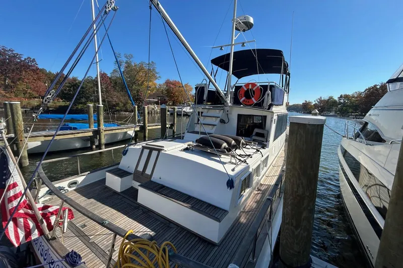 Radius Yacht Photos Pics 1986 Grand Banks 42 Classic yacht docked at a marina, featuring a spacious deck and canopy.