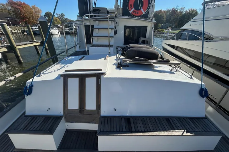 Radius Yacht Photos Pics 1986 Grand Banks 42 Classic yacht docked, showcasing rear deck and cabin entrance.