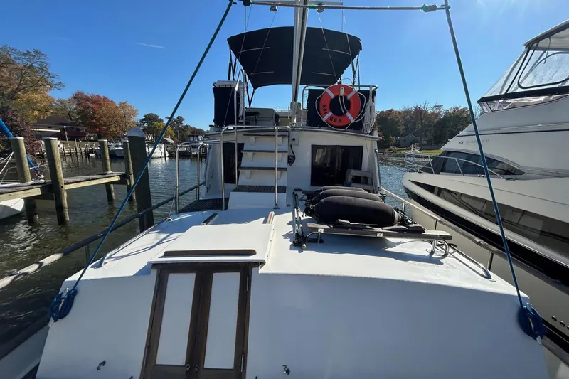 Radius Yacht Photos Pics 1986 Grand Banks 42 Classic yacht docked, featuring a spacious deck and canopy.