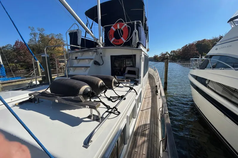 Radius Yacht Photos Pics 1986 Grand Banks 42 Classic yacht docked, featuring deck equipment and lifebuoy.