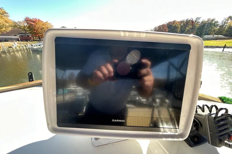 Radius Yacht Photos Pics Garmin navigation display on 1986 Grand Banks 42 Classic boat, reflecting surroundings.