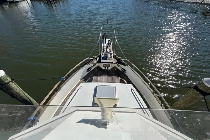 Radius Yacht Photos Pics 1986 Grand Banks 42 Classic yacht bow view, docked on calm water.