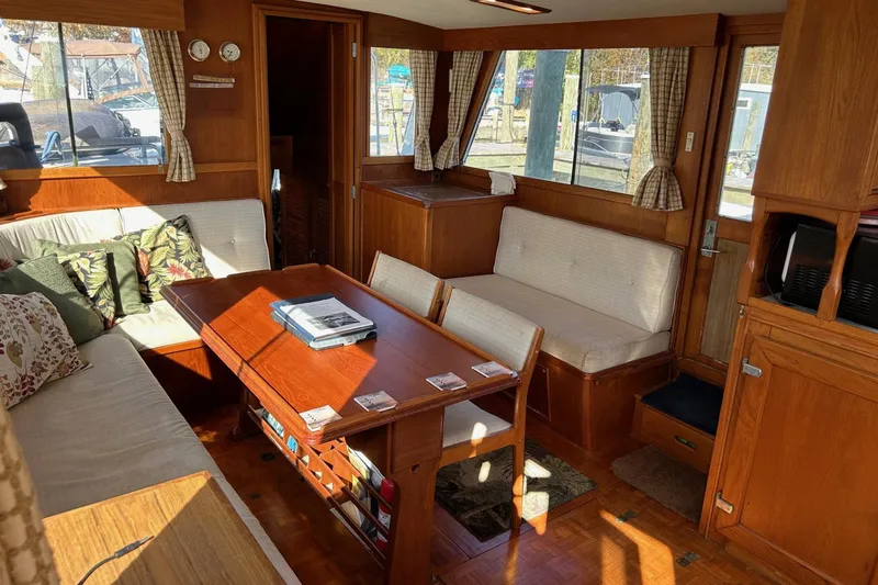 Radius Yacht Photos Pics Interior of 1986 Grand Banks 42 Classic yacht with wooden furnishings and cozy seating.