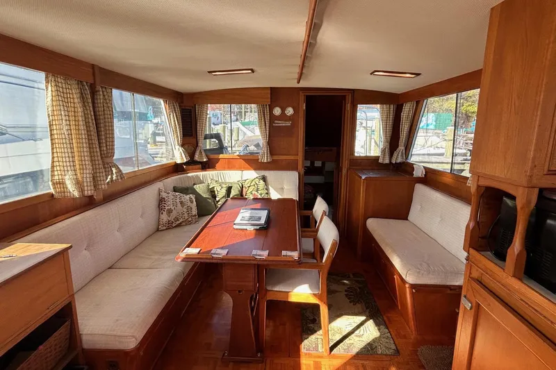 Radius Yacht Photos Pics Interior of 1986 Grand Banks 42 Classic yacht with cozy seating and wooden furnishings.