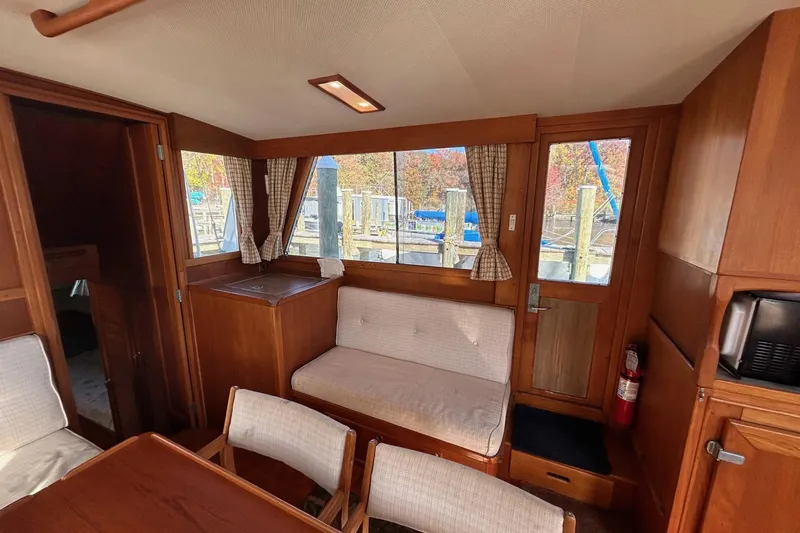 Radius Yacht Photos Pics Interior of 1986 Grand Banks 42 Classic yacht with wood paneling and seating area.