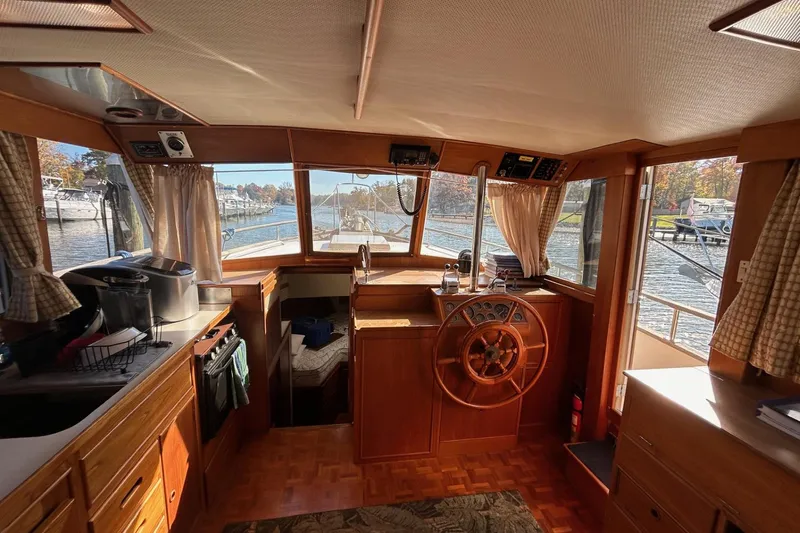 Radius Yacht Photos Pics Interior of 1986 Grand Banks 42 Classic yacht with wooden helm and cozy cabin.