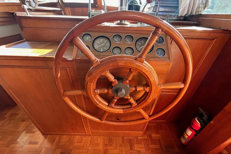 Radius Yacht Photos Pics Wooden helm of 1986 Grand Banks 42 Classic yacht with gauges and fire extinguisher.