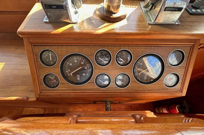 Radius Yacht Photos Pics 1986 Grand Banks 42 Classic dashboard with gauges and controls in wooden panel.