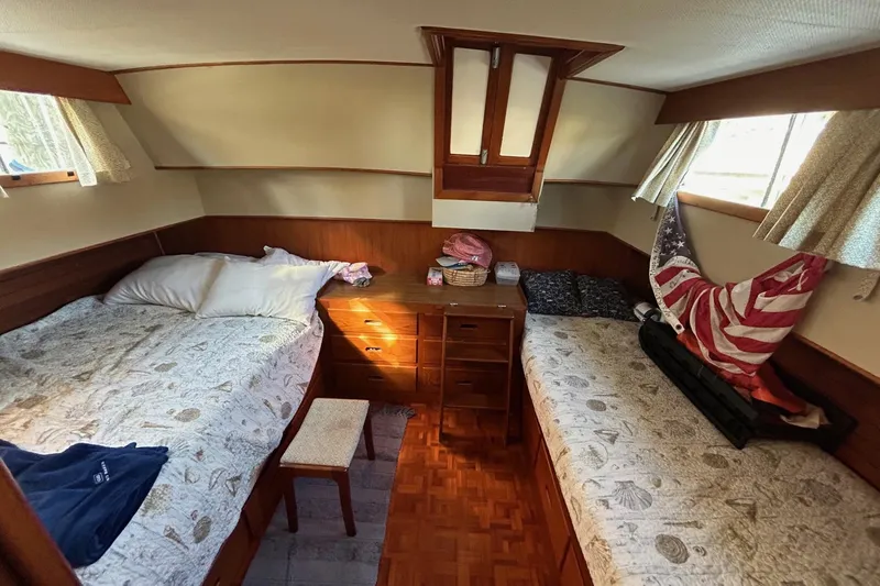 Radius Yacht Photos Pics Cozy cabin interior of 1986 Grand Banks 42 Classic with twin beds and wooden furnishings.