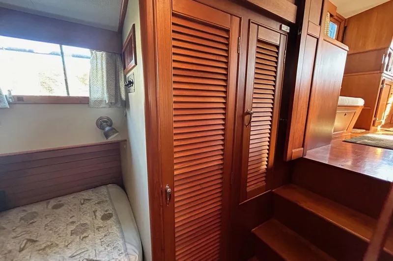 Radius Yacht Photos Pics 1986 Grand Banks 42 Classic interior with wooden cabinetry and cozy sleeping area.